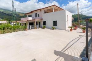 a house with a large driveway in front of it at Zì Rosa B&B in San Nicola Arcella