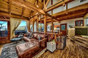 a living room with a leather couch and a table at LX07 Skyfall lakeview house with dry sauna close to Edgewood in Zephyr Cove