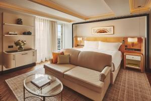 a hotel room with a bed and a couch at Claridge's, Maybourne in London