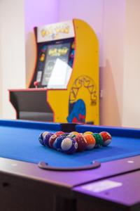 a ping pong table with a pinball machine at Entire Luxury Home in Old Trafford, next to MUFC in Manchester