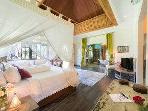a bedroom with a bed and a living room at Sayang d'Amour in Seminyak