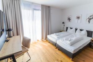 a bedroom with a bed and a table and a desk at Helios Berlin Apartments in Berlin