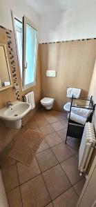 a bathroom with a sink and a toilet at APPARTAMENTO A DUE PASSI DAL MARE By VILLA FIORITA in Cattolica