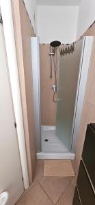 a shower with a glass door in a bathroom at APPARTAMENTO A DUE PASSI DAL MARE By VILLA FIORITA in Cattolica