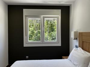 a bedroom with a black wall and a window at Apartamentos Toffe in Outes +74 photos