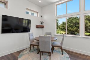 a dining room with a table and chairs and a window at Miramar Oasis - Ocean View, Steps2Beach, Roof Deck in El Granada