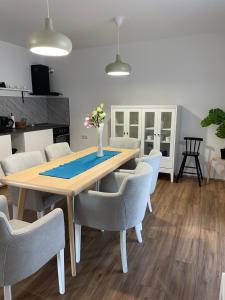 a dining room with a wooden table and chairs at Deluxe apartment Magnolia 2 in Belgrade