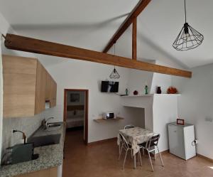 a kitchen and dining room with a table in a room at Monte da Vinha Nova in Santiago do Cacém
