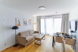 a living room with a couch and a table at Helios Berlin Apartments in Berlin