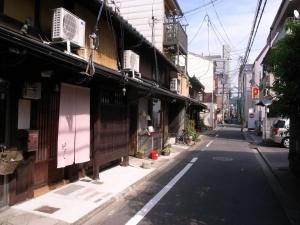 an empty street in an asian city with buildings at 京町家 近よし in Kyoto