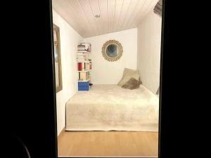 a small bedroom with a bed in a room at Graine de Paradis - Tiny House in Le Landeron