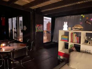 a room with a couch and a table and a window at Graine de Paradis - Tiny House in Le Landeron