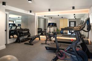 a gym with several treadmills and exercise bikes at The Coachman Hotel in South Lake Tahoe