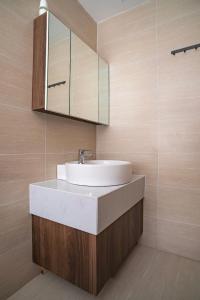 a bathroom with a sink and a mirror at Homestay Huế ơi 2 in Thôn Văn Dương