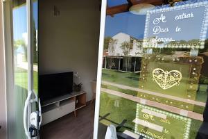 two pictures of a room with a window with a sign at Aconchego à Beira-Mar em Gov Celso Ramos/SC in Armação +19 photos