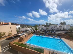 a swimming pool on the roof of a building at Ocean Dream Apartment in Playa Jandia