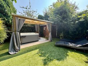 a backyard with a hot tub and a gazebo at 8min to City, Hot Tub House, Fire Pit, Free Parking in Longbenton