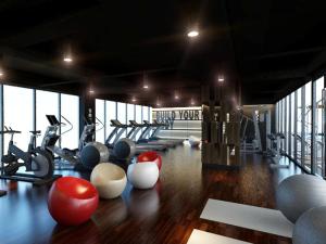 a gym with exercise bikes and balls on the floor at Louis Kienne Hotel Simpang Lima in Semarang