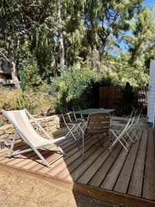 two chairs and a table on a wooden deck at Villa les Lys 2 in La Seyne-sur-Mer +3 photos