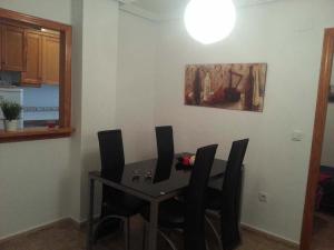 una mesa de comedor y sillas en una habitación en Zoa Apartment, en Torrevieja