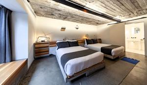 a bedroom with two beds and a wooden ceiling at Hotel Carlota in Mexico City +54 photos