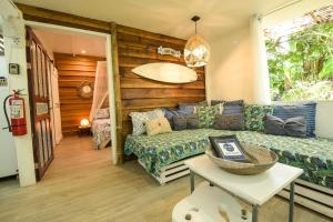 a living room with a couch and a table at UP! HOUSE Costa Rica ~ 2 Casitas in Playa Chiquita in Talamanca