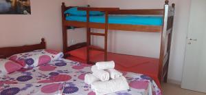 a bedroom with two bunk beds with towels on a bed at BELVEDERE Shengjin in Lezhë