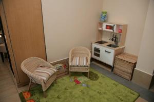 a small room with two chairs and a kitchen at Penzion a Restaurant Barbora in Kutná Hora