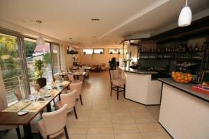 a restaurant with tables and chairs and a bar at Penzion a Restaurant Barbora in Kutná Hora