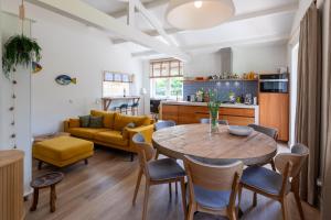 a kitchen and living room with a table and chairs at Beautifully located dune villa near Noordwijk beach in Noordwijk