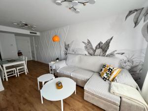 a living room with a couch and a table at Jardines del Porvenir 2 in Puerto Real