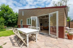 a tiny house with a table and chairs on a patio at Beautifully located dune villa near Noordwijk beach in Noordwijk +22 photos
