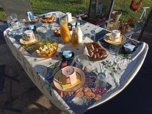 a table with food and drinks on it at La Bruyère - B & B - in Tréban