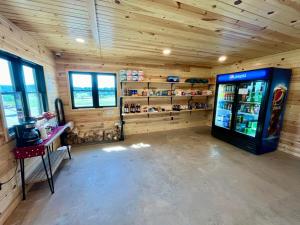 a shop with a soda machine in a wooden room at Pine Haven Lodging in Rockerville