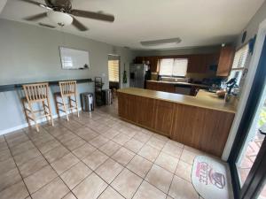 a kitchen with a counter and chairs in a room at Private Room - Free Parking - Kendall Area in Miami