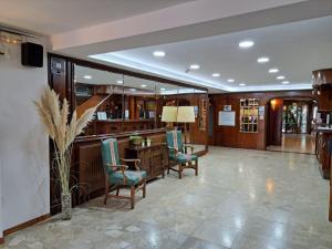 a lobby with chairs and a desk in a building at Vintage Hotel Mercedes in Lloret de Mar