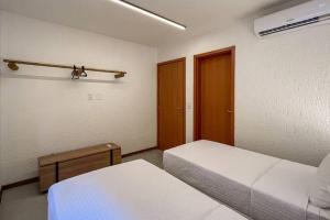 a small room with two beds and a closet at Villa Kamby Milagres B003 in São Miguel dos Milagres +46 photos