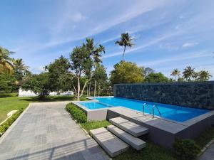 an image of a swimming pool at a house at Palmgrove Lake Resort in Alleppey