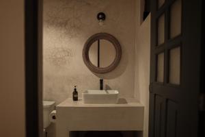 a bathroom with a sink and a mirror at Narrativ Lofts in Campeche +63 photos