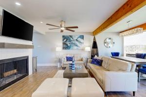 a living room with a couch and a fireplace at 104 World of Tennis Square #104 in Lakeway