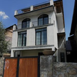 a building with a wooden gate in front of it at Boutique hotel mestia in Mestia