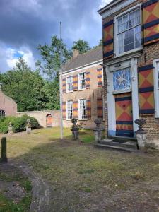 a house with a painting on the side of it at Zuidewijn in Sprang-Capelle