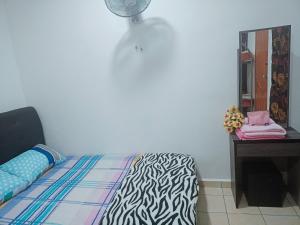 a bedroom with a bed and a desk and a mirror at Lading Amas Resort in Rengit