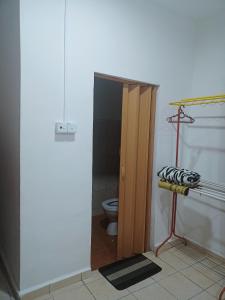 a bathroom with a toilet and a wooden stall at Lading Amas Resort in Rengit