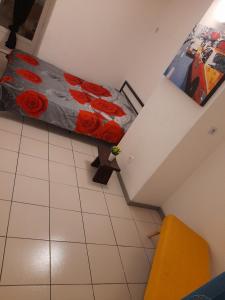 a bedroom with a bed with red roses on it at Magnifique appartement in Argelès-sur-Mer