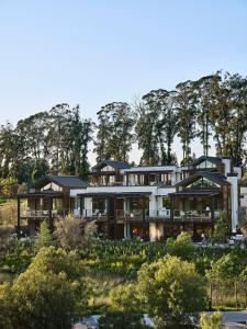an image of a house with trees in the background at Stanly Ranch, Auberge Collection in Napa