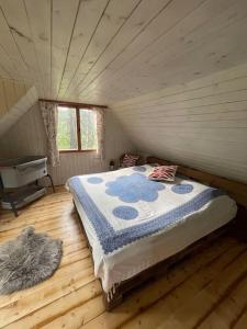 a bedroom with a bed in a small room at Chata nad řekou Otavou in Vojníkov +33 photos