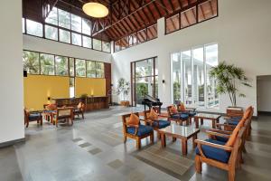 a lobby with chairs and tables and a piano at Turyaa Kalutara in Kalutara