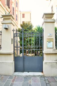 a blue gate in front of a building at Dormi da noi in Ancona +5 photos