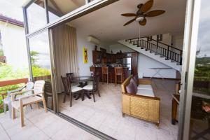 a living room with a staircase and a table and chairs at Ocean and Mountain View Villa in Playa Hermosa